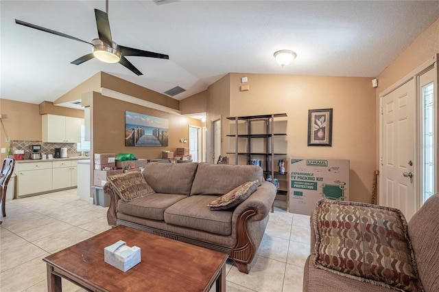 tiled living room with vaulted ceiling and ceiling fan