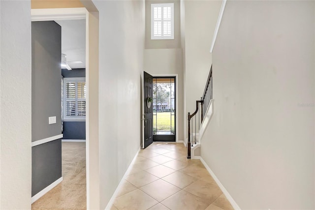 foyer entrance with a healthy amount of sunlight and light tile patterned floors