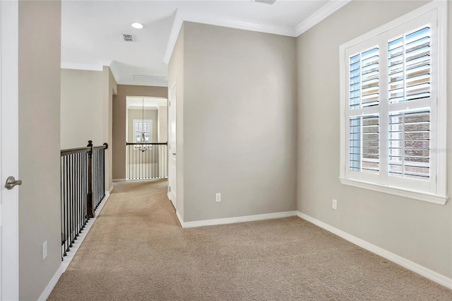 unfurnished room featuring ornamental molding and light carpet