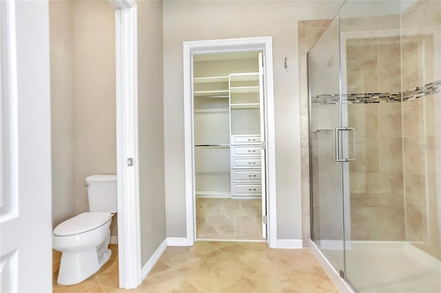 bathroom with an enclosed shower, tile patterned floors, and toilet