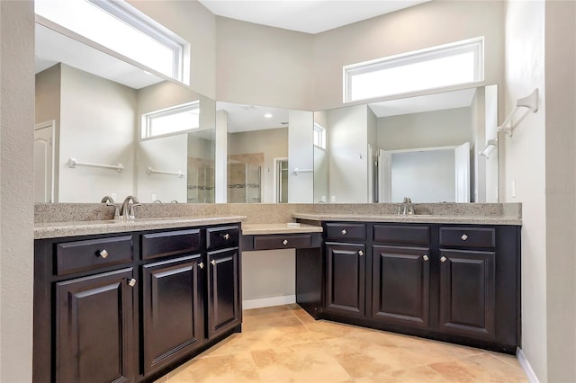 bathroom with walk in shower and vanity