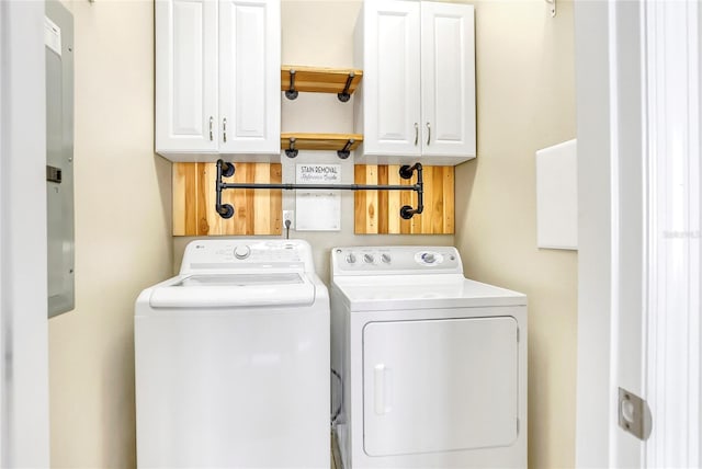 laundry room featuring washer and clothes dryer and cabinets