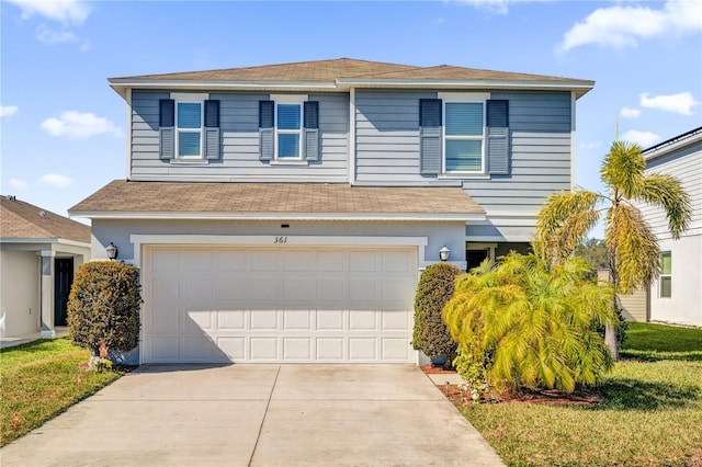 view of front property with a garage and a front lawn