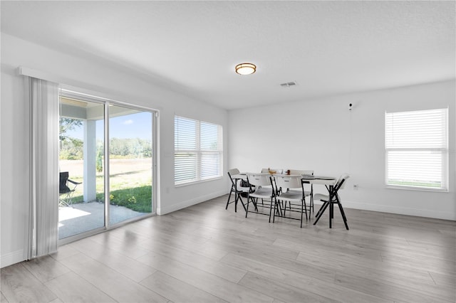 dining space featuring light wood-type flooring