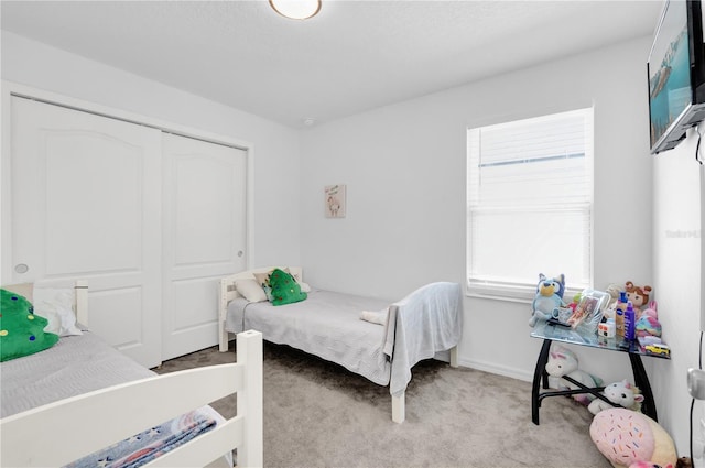 bedroom with light colored carpet and a closet