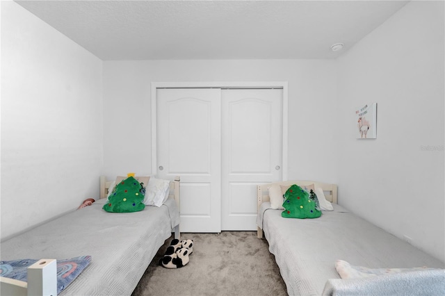 bedroom featuring light carpet and a closet