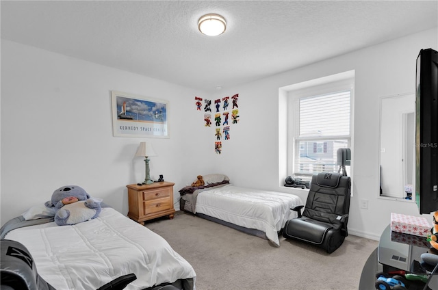 bedroom with carpet floors and a textured ceiling