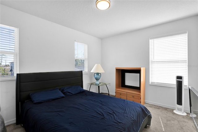 carpeted bedroom featuring multiple windows