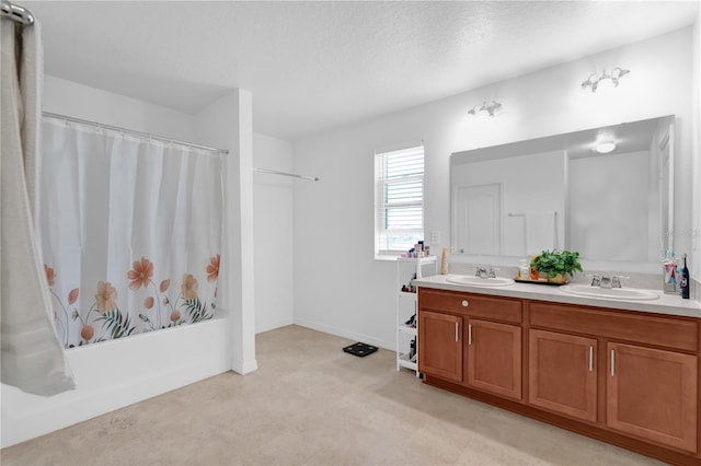 bathroom featuring vanity, shower / bathtub combination with curtain, and a textured ceiling