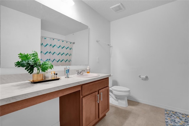 bathroom with vanity, walk in shower, a textured ceiling, and toilet