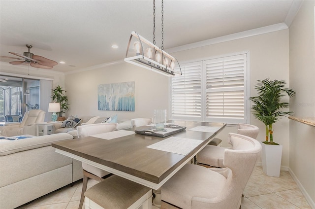 tiled dining space with ornamental molding and ceiling fan