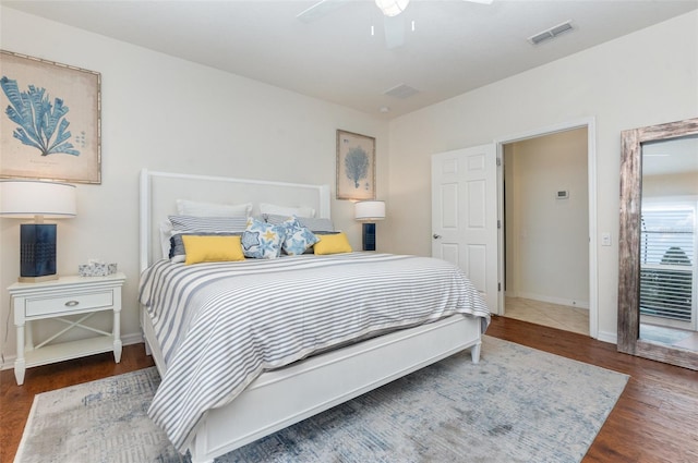 bedroom with ceiling fan and dark hardwood / wood-style flooring