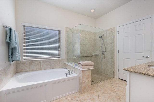 bathroom featuring tile patterned flooring, vanity, and separate shower and tub