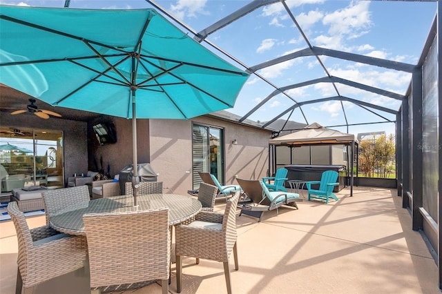 view of patio / terrace with a grill, ceiling fan, glass enclosure, a hot tub, and a gazebo