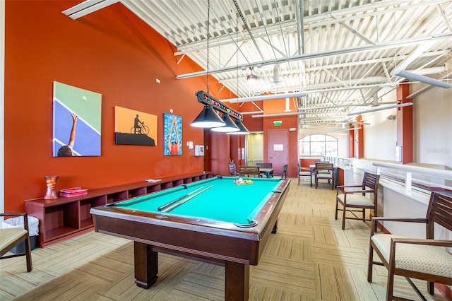 rec room featuring pool table and a towering ceiling