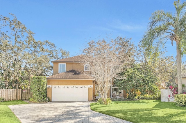 front of property with a garage and a front lawn