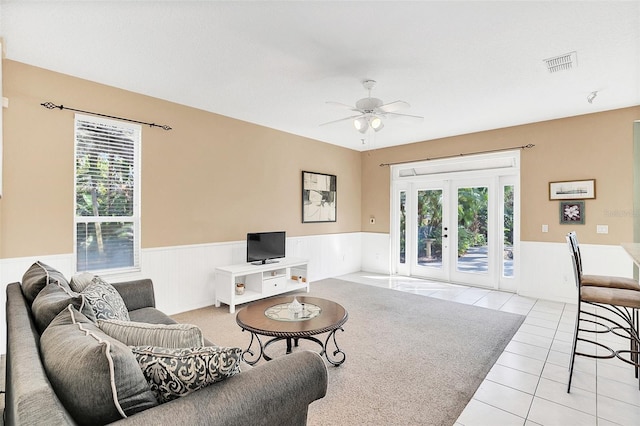 living room with light tile patterned floors, french doors, and ceiling fan