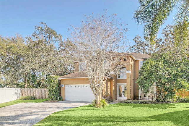 view of front of house featuring a garage, french doors, and a front lawn