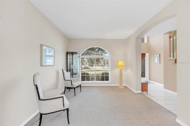 sitting room featuring light colored carpet