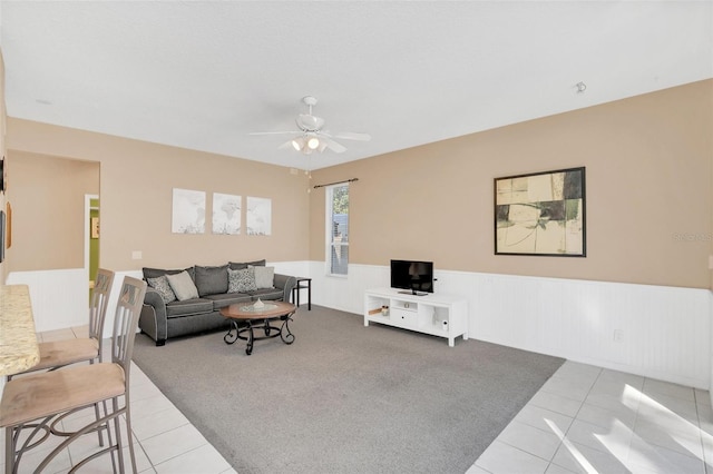 living room featuring ceiling fan and light tile patterned floors