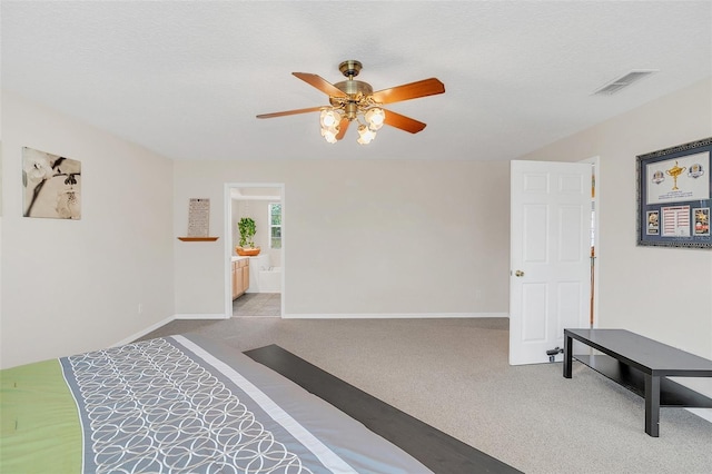 interior space with ceiling fan, a textured ceiling, and carpet flooring