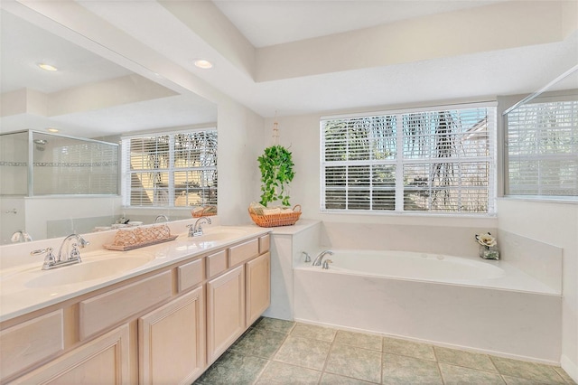 bathroom featuring tile patterned flooring, vanity, plenty of natural light, and separate shower and tub