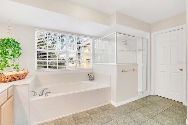 bathroom with tile patterned floors, vanity, and separate shower and tub