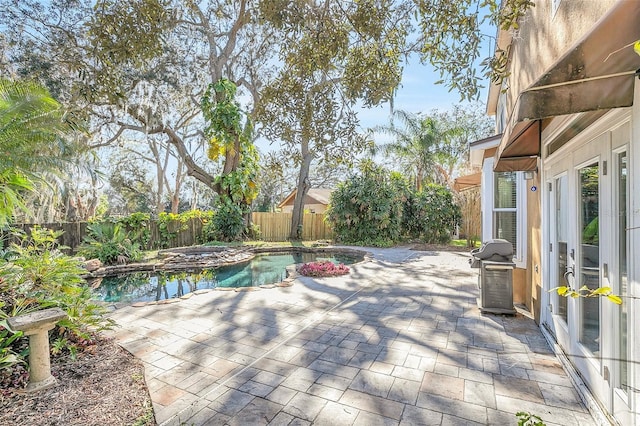 view of swimming pool featuring an in ground hot tub, grilling area, a patio area, and french doors