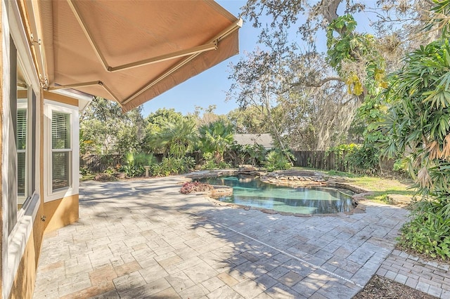 view of pool with a jacuzzi and a patio