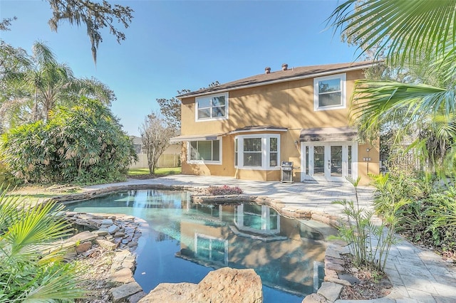 rear view of property featuring a patio and french doors