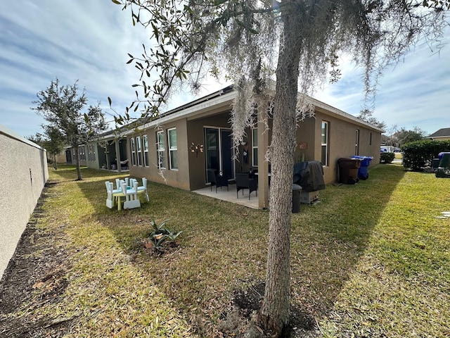 rear view of property featuring a yard