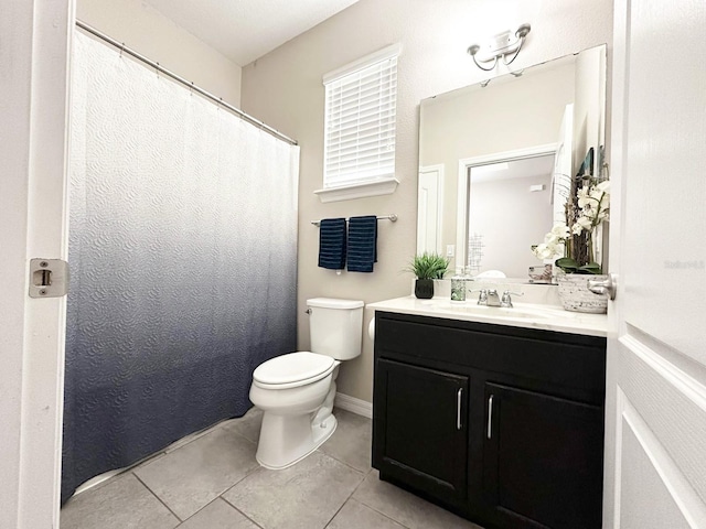 bathroom featuring tile patterned floors, vanity, and toilet