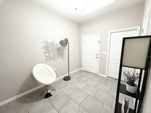 tiled entrance foyer featuring a skylight