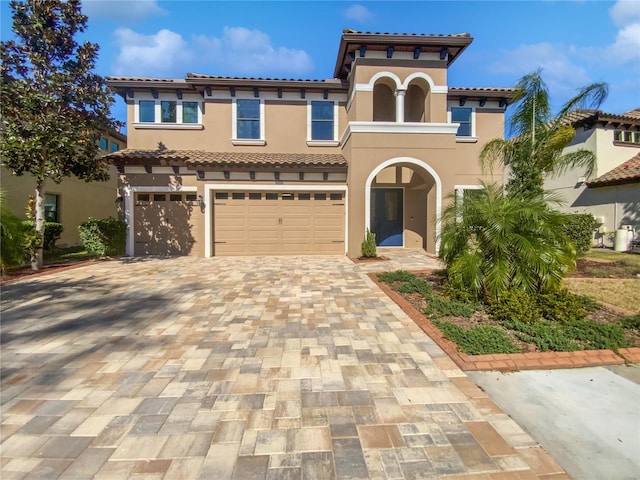 mediterranean / spanish-style house with a garage