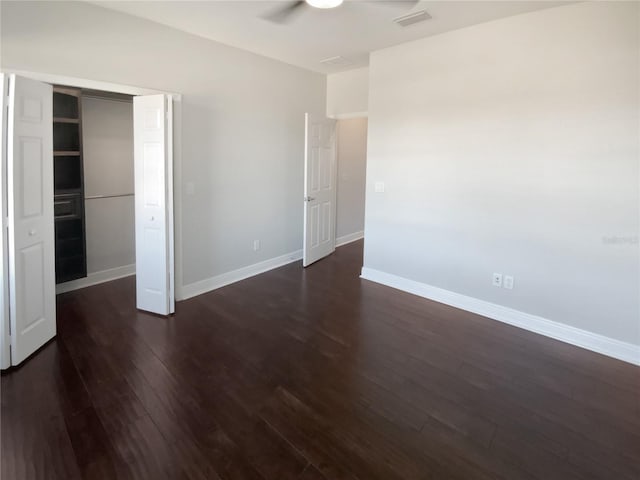 unfurnished bedroom with a closet and dark hardwood / wood-style floors