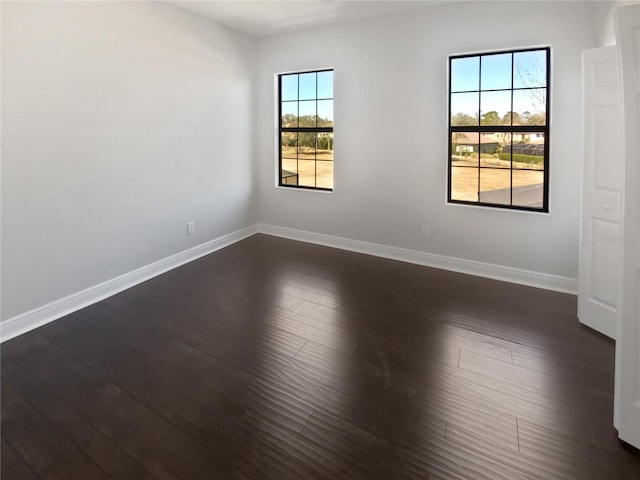 spare room featuring dark hardwood / wood-style flooring