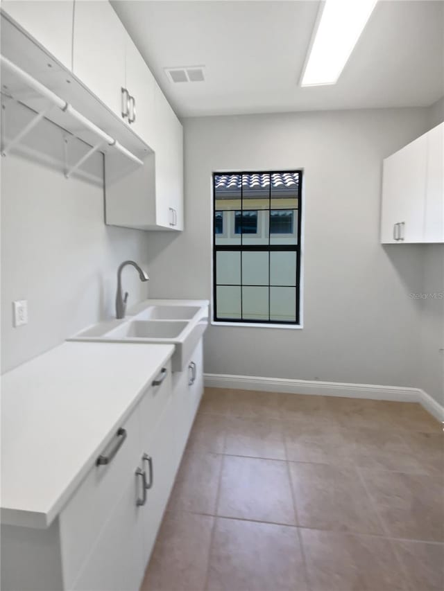 washroom with sink and light tile patterned floors