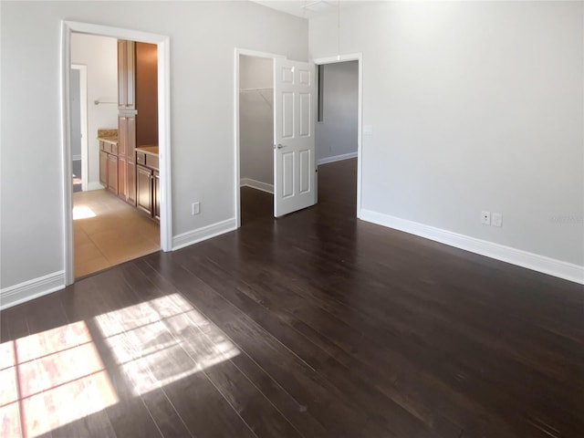 unfurnished room with dark wood-type flooring