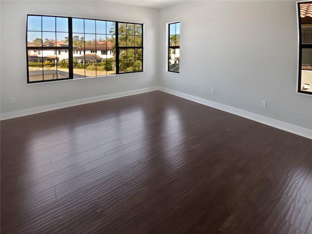 spare room with dark hardwood / wood-style floors