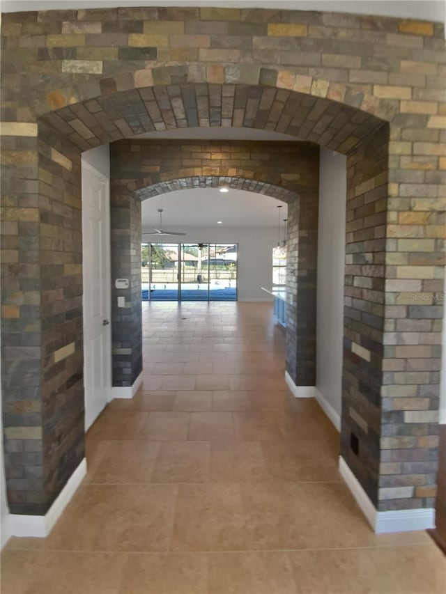 hall with tile patterned floors