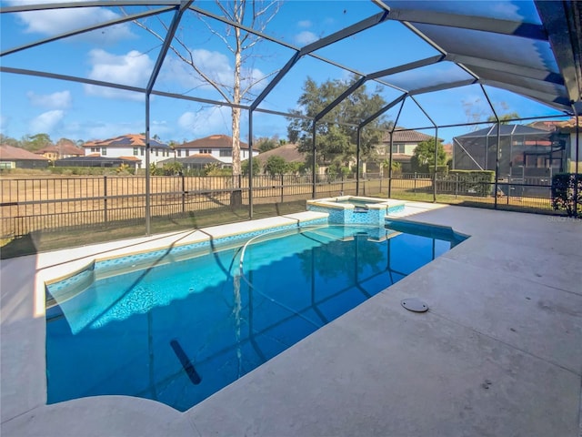 view of pool featuring an in ground hot tub, a lanai, and a patio