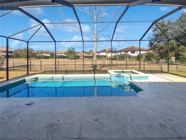 view of pool with a lanai, a patio, and an in ground hot tub