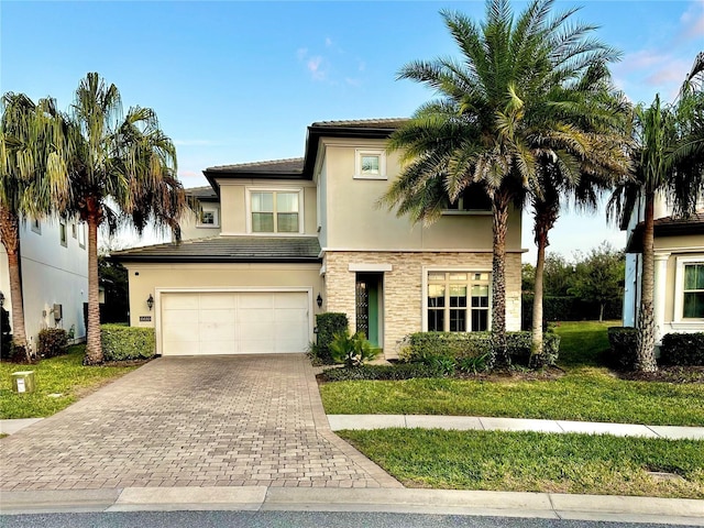 view of front of house featuring a garage and a front lawn