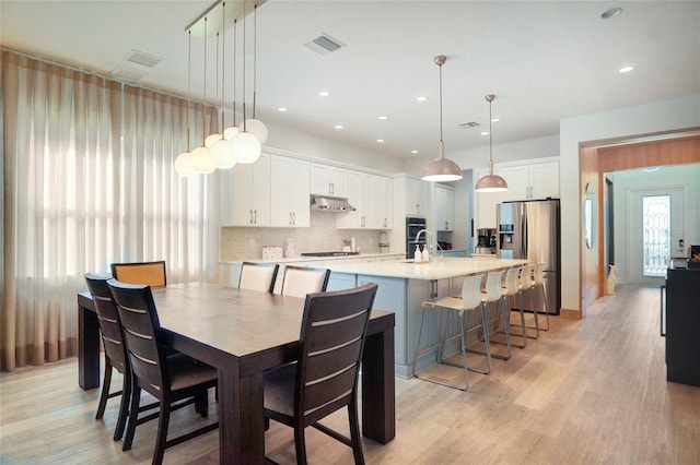 dining area with recessed lighting, visible vents, and light wood-style flooring