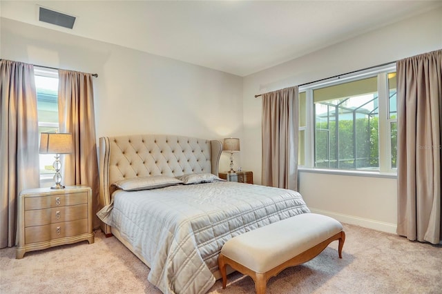 bedroom featuring light colored carpet, visible vents, and baseboards