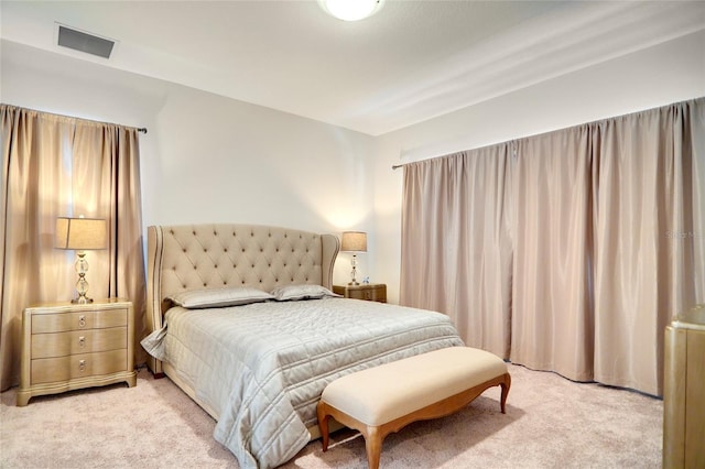 bedroom featuring light colored carpet and visible vents