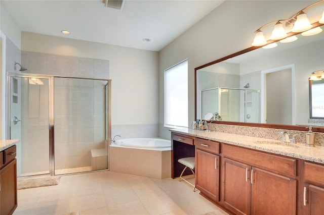 bathroom featuring vanity, tile patterned flooring, and plus walk in shower