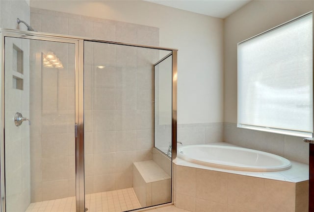 bathroom with shower with separate bathtub