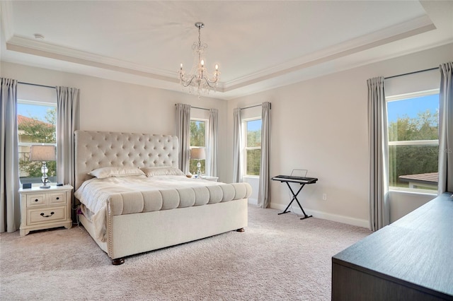 bedroom with crown molding, a tray ceiling, and light colored carpet