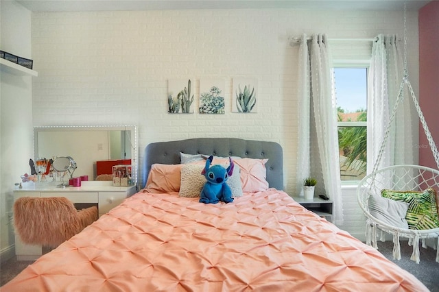 bedroom featuring brick wall